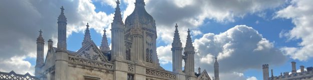 The cover photo shows the spires of the King's College Porter's Lodge against a sky of dappled clouds lit from behind. The Porter's Lodge is a landmark on the street outside, King's Parade, but this is a view from the front lawn inside the College. I took this picture on the day of my first graduation at King's.
